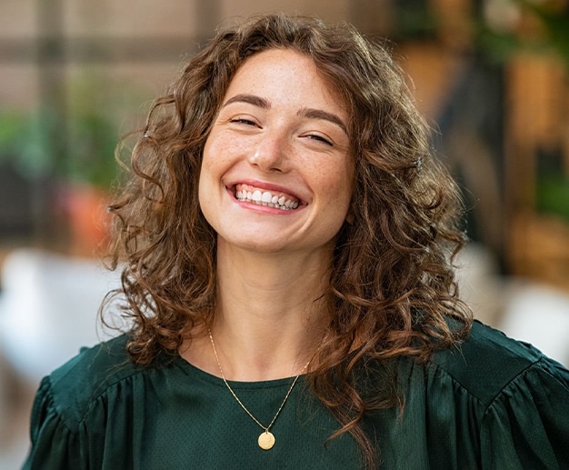 Patient smiling confidently after cosmetic dentistry treatment