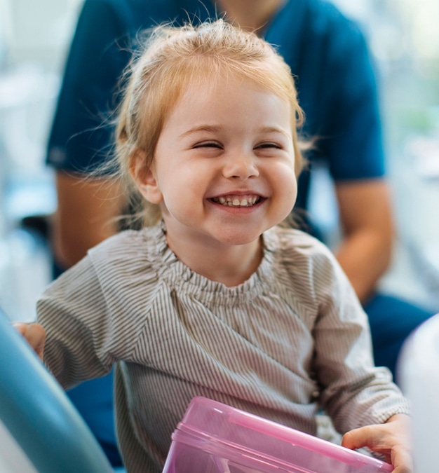 Smiling kid at her first dental appointment frisco tx